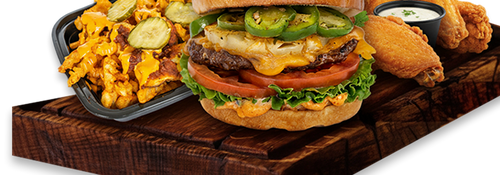 An iniBurger halal burger served on a wooden board with wings and loaded fries