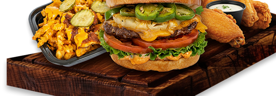 An iniBurger halal burger served on a wooden board with wings and loaded fries