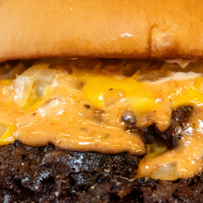 A Burger Bodega halal smashburger with crispy edges on a potato bun