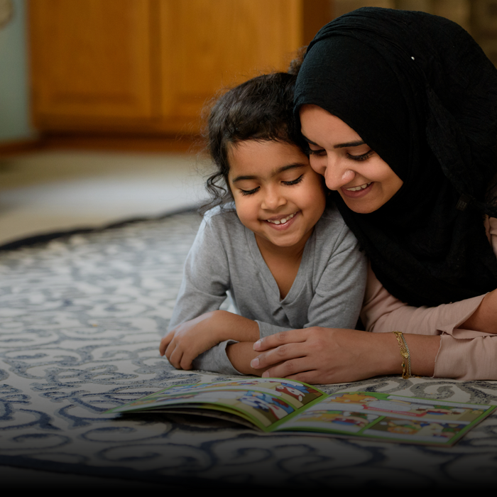 A mother and daughter reading a Noor Kids Islamic comic book together at home
