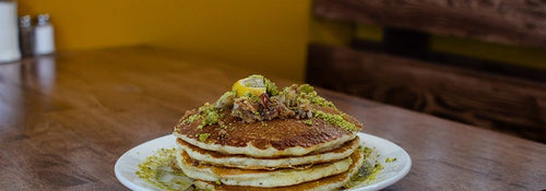 A stack of baklava pancakes topped with crushed pistachios and walnuts at Brookline Lunch in South Boston