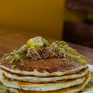 A stack of baklava pancakes topped with crushed pistachios and walnuts at Brookline Lunch in South Boston