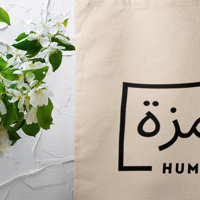 A personalized tote bag with a name printed in Arabic, a practical Umrah gift