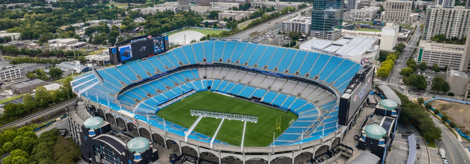 Aerial view of a wide NFL football stadium bowl on a sunny fall afternoon