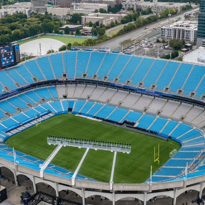 Aerial view of a wide NFL football stadium bowl on a sunny fall afternoon