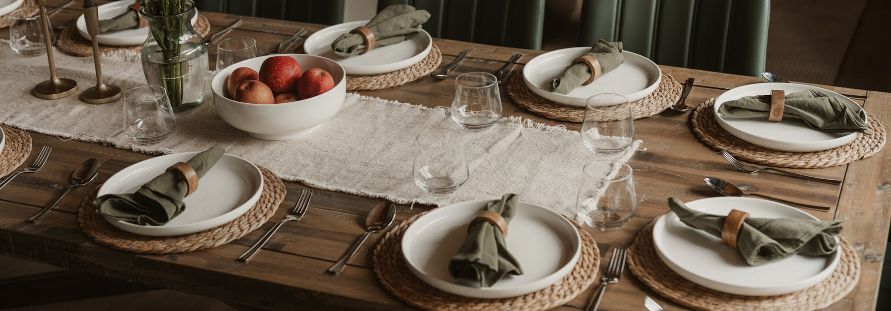 An elegantly set wooden dining table ready to welcome guests