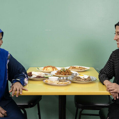 Asian Homecook owner Toyuba Amir Ali and her daughter Aishah Hamid share a laugh over Malaysian dishes at their West Ridge restaurant in Chicago
