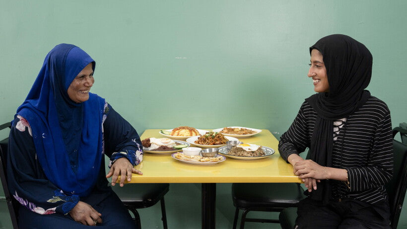 Asian Homecook owner Toyuba Amir Ali and her daughter Aishah Hamid share a laugh over Malaysian dishes at their West Ridge restaurant in Chicago