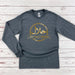 a gray shirt with gold arabic writing on it