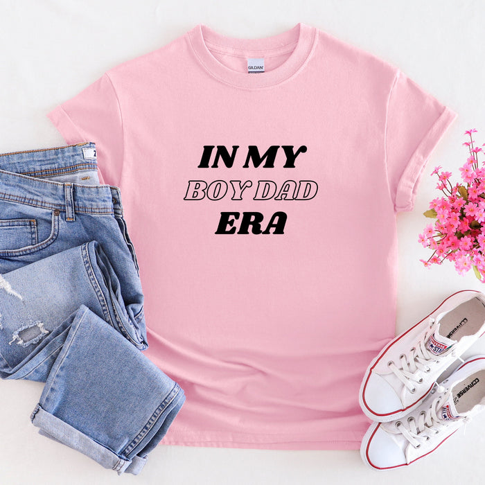 a pink shirt that says in my boyfriend era next to a pair of jeans and