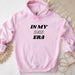 a pink hoodie that says in my dad era