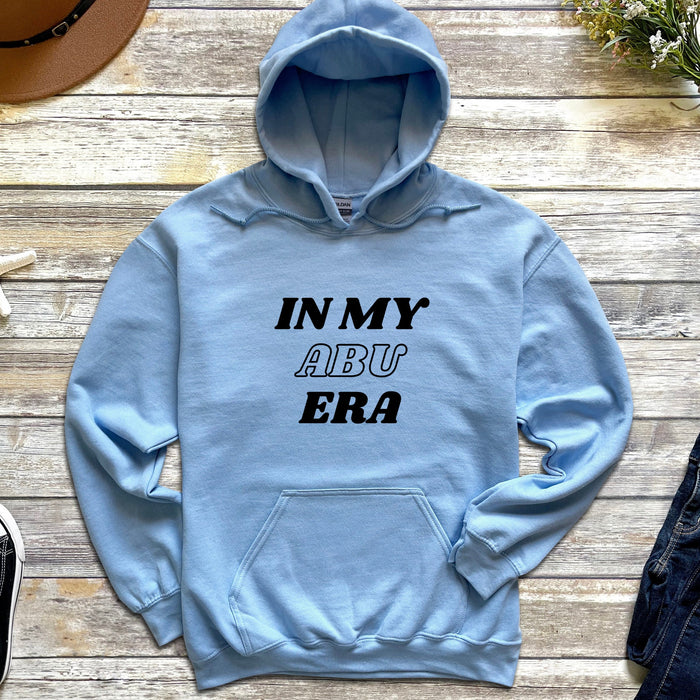 a blue hoodie that says in my aru era