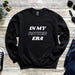 a black sweater that says in my father era