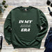 a green sweatshirt with the words in my area printed on it