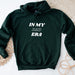 a green hoodie with the words in my dad era printed on it