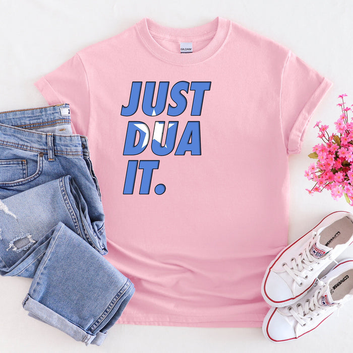 a pink t - shirt that says just dua it next to a pair of